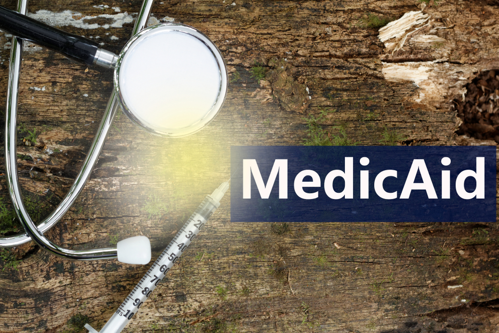 Word,Medicaid,On,Wooden,Background,With,Stethoscope,And,Syringe
